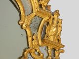 a mirror with a gold frame and a mirror with a picture on it