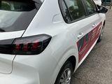 the back of a white car parked on the side of the road