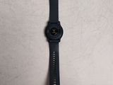 a close up of a watch on a table with a white background