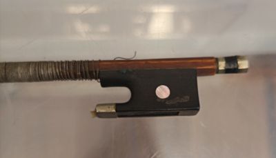 un archet de violon attaché à une pièce de bois