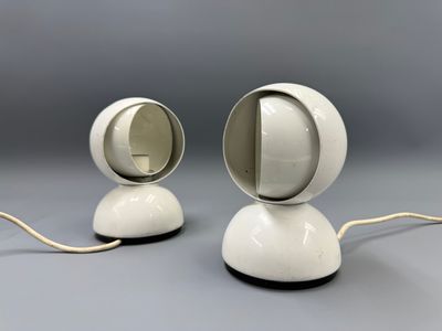 two white lamps sitting on top of a table next to each other
