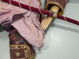a doll that is sitting on top of a wooden pole
