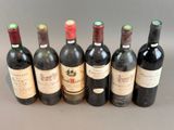 several bottles of wine are lined up on a table