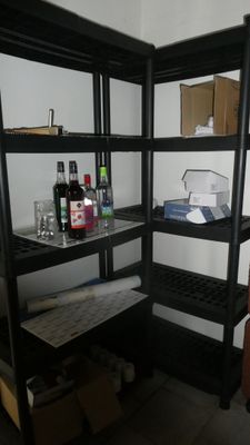 a room with a shelf and a chair in it