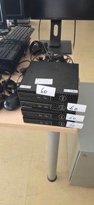 a lot of computer equipment on the desk in this room
