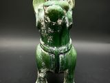 a green statue of an elephant on a black background