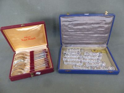 two boxes with silverware in them on a table