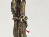 a statue of a bird that is on top of a pole