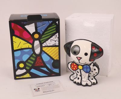 the small dog figurine is sitting next to a box of tissues