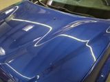 a blue car that is parked in a garage
