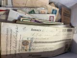 a pile of old letters and envelopes in a box