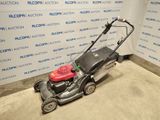 an image of a lawn mower parked in a room