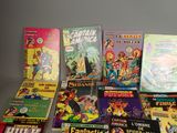a lot of comic books that are on the table