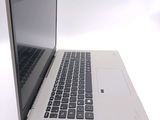 a laptop that is open on a white surface