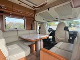 an image of a camper with a table and chairs