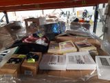 a table with many boxes of items on it in a warehouse