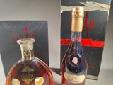 two bottles of liquor sitting next to each other on top of a table