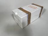a white box with a brown ribbon on top of it