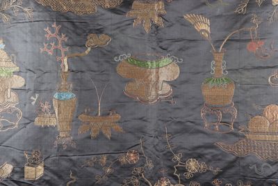 a black cloth with a picture of animals and plants on it