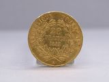 a gold coin sitting on top of a white surface