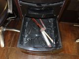 a trash can with a brush inside of it on the floor
