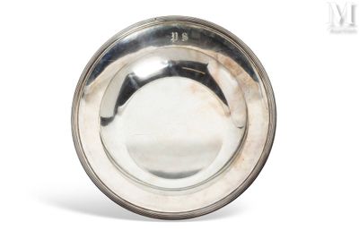 silver plate on white background with reflection of the bowl in the middle