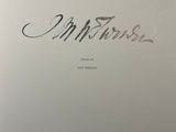 a white book with a black writing on the cover
