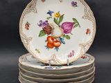 four plates are stacked on top of each other with flowers on them