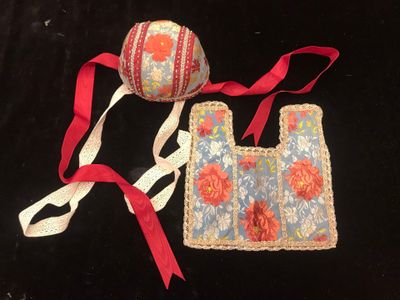 two pieces of cloth and a ball on a black surface