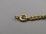 a close up of a gold chain with a clasp on it