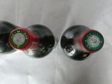 two bottles of wine that are sitting on a table