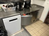 a small kitchen with a dishwasher, coffee maker, and other appliances