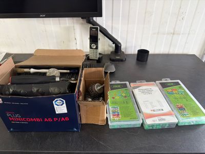 un bureau sur lequel se trouvent un ordinateur et tout un tas de cartons