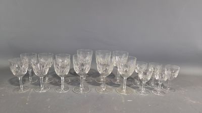 many empty wine glasses lined up on a table