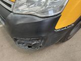 a close up of the front bumper of a yellow van