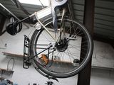 a bike that is hanging from the ceiling in a garage
