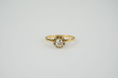 a yellow gold ring with a diamond in the center