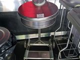 a red cup sitting on top of a table in a kitchen