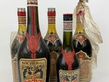 several bottles of liquor are lined up on a white surface