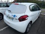 a white car parked in a parking lot next to other cars