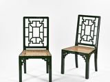 pair of black chairs with wicker seat and backrests