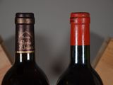 two bottles of wine sitting next to each other on a table