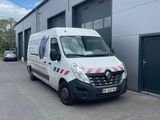 a white van parked in front of a building next to a garage