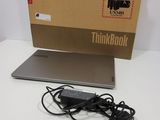a laptop sitting on a table with a box on top of it