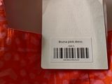 an orange bag with a label on it that says bruno park dress