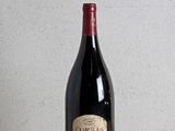 a bottle of wine sitting on a wooden table