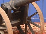 an old cannon sitting on top of a wooden cart