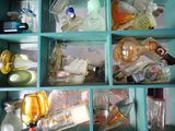 many bottles of alcohol and other things in this cabinet