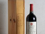 a bottle of wine sitting next to a wooden box