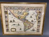 an old map of the americas is displayed in a gold frame